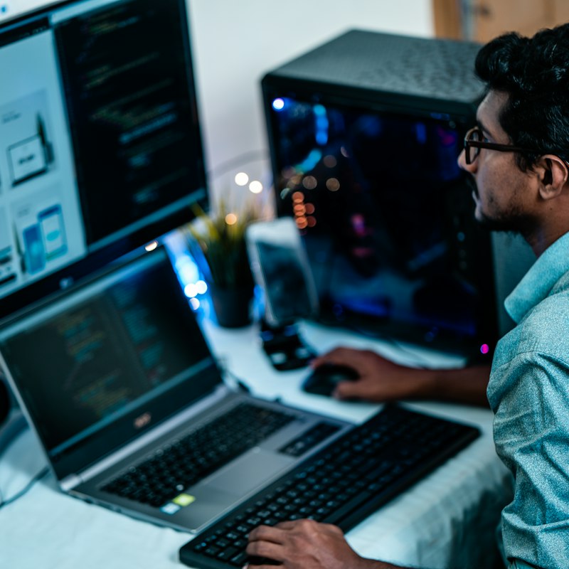 Technician working on a laptop at a home office desk